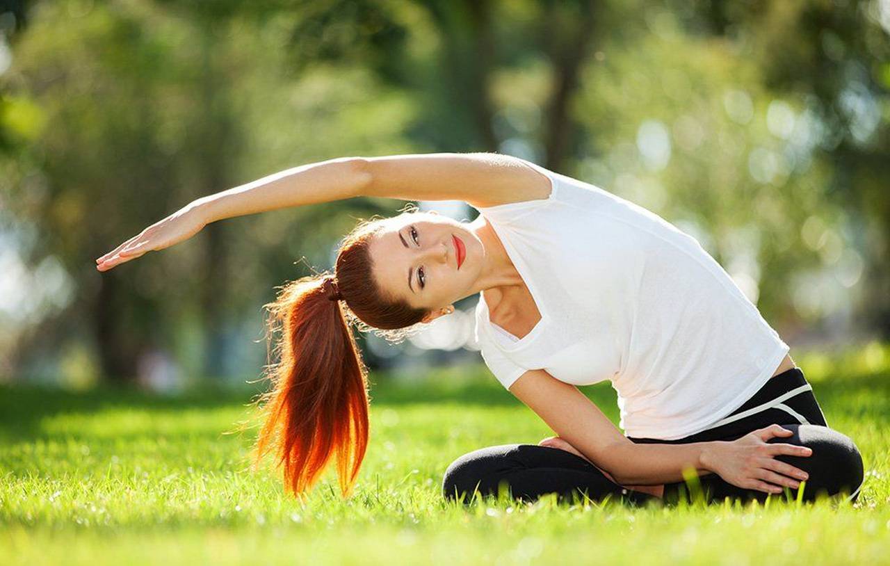 mulher no parque praticando yoga mudança no estilo de vida